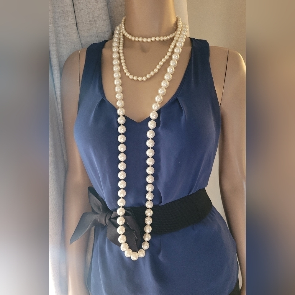 Two long strands of faux pearls